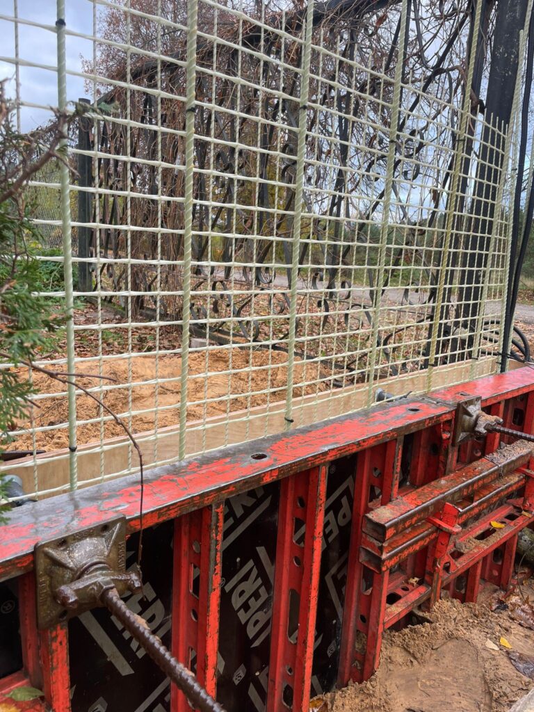 REBARMAT GFRP mesh and composite rebars installed in concrete formwork for corrosion-free foundation and retaining wall construction.